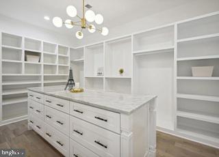 7709 Sebago Road Bethesda, MD 20817 - Photo 41 of 68 a kitchen with cabinets stainless steel appliances and a chandelier