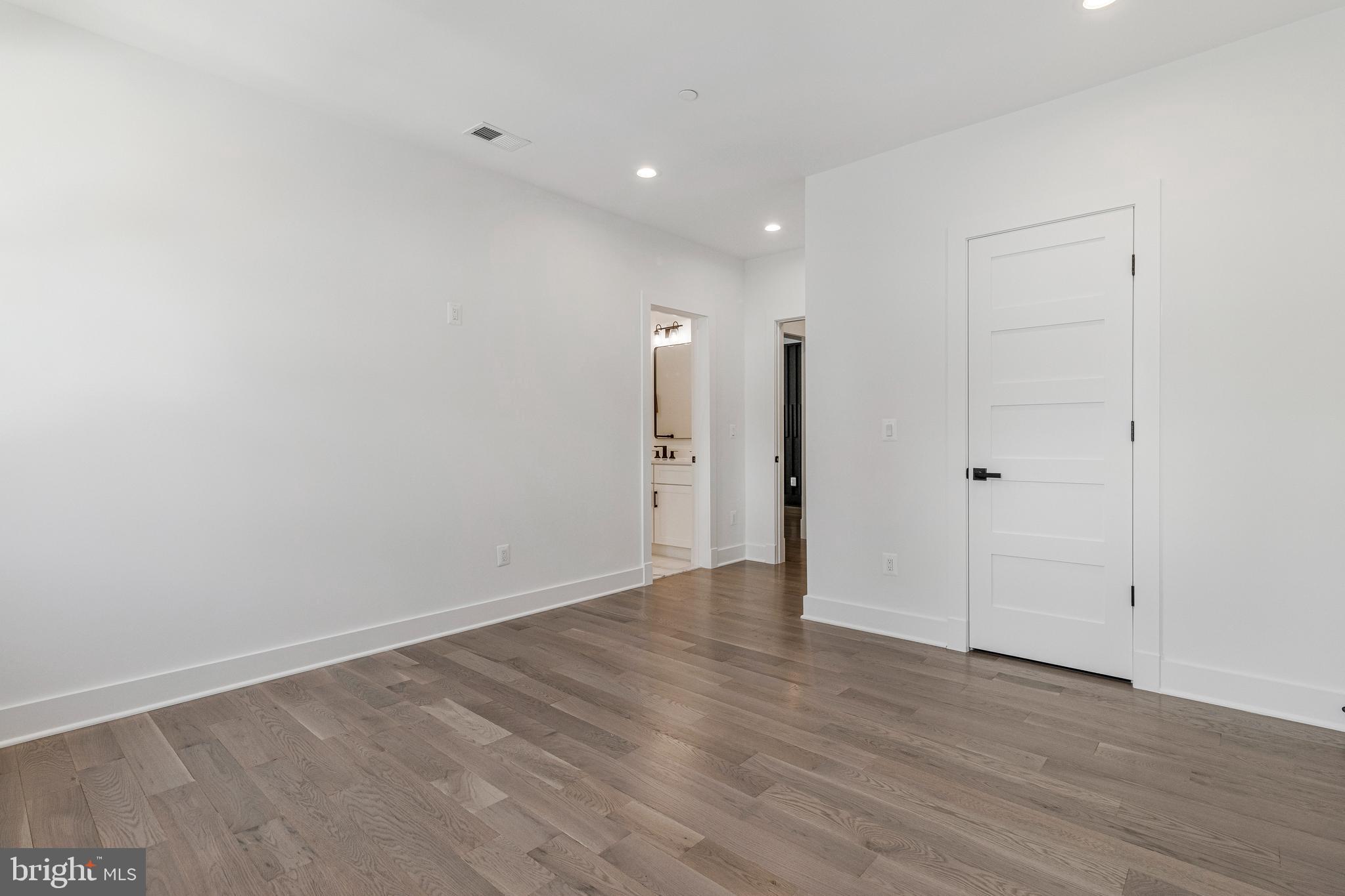 7709 Sebago Road Bethesda, MD 20817 - Photo 50 of 65 a view of an empty room with wooden floor