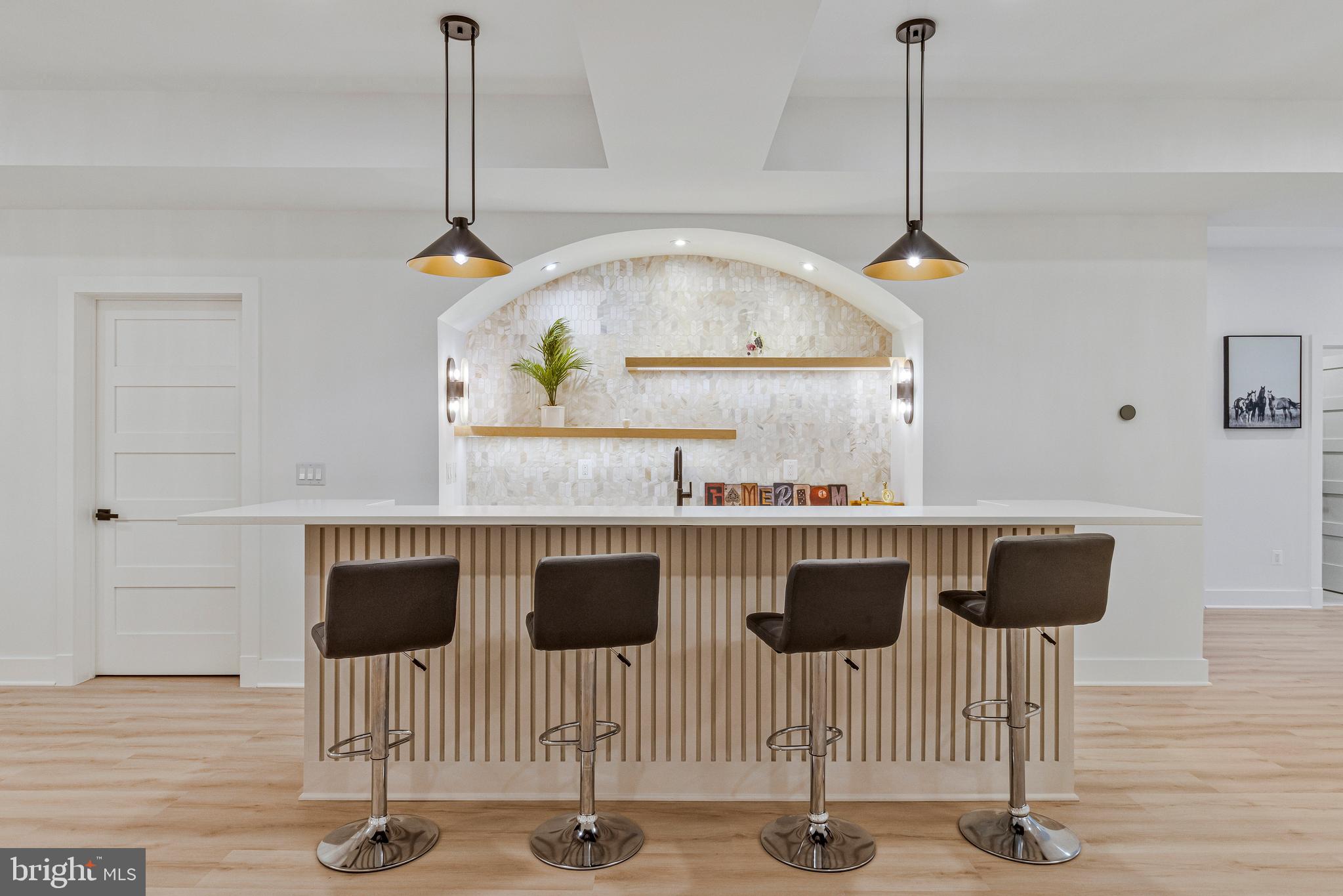 7709 Sebago Road Bethesda, MD 20817 - Photo 61 of 68 a kitchen with a table chairs and a wooden floor