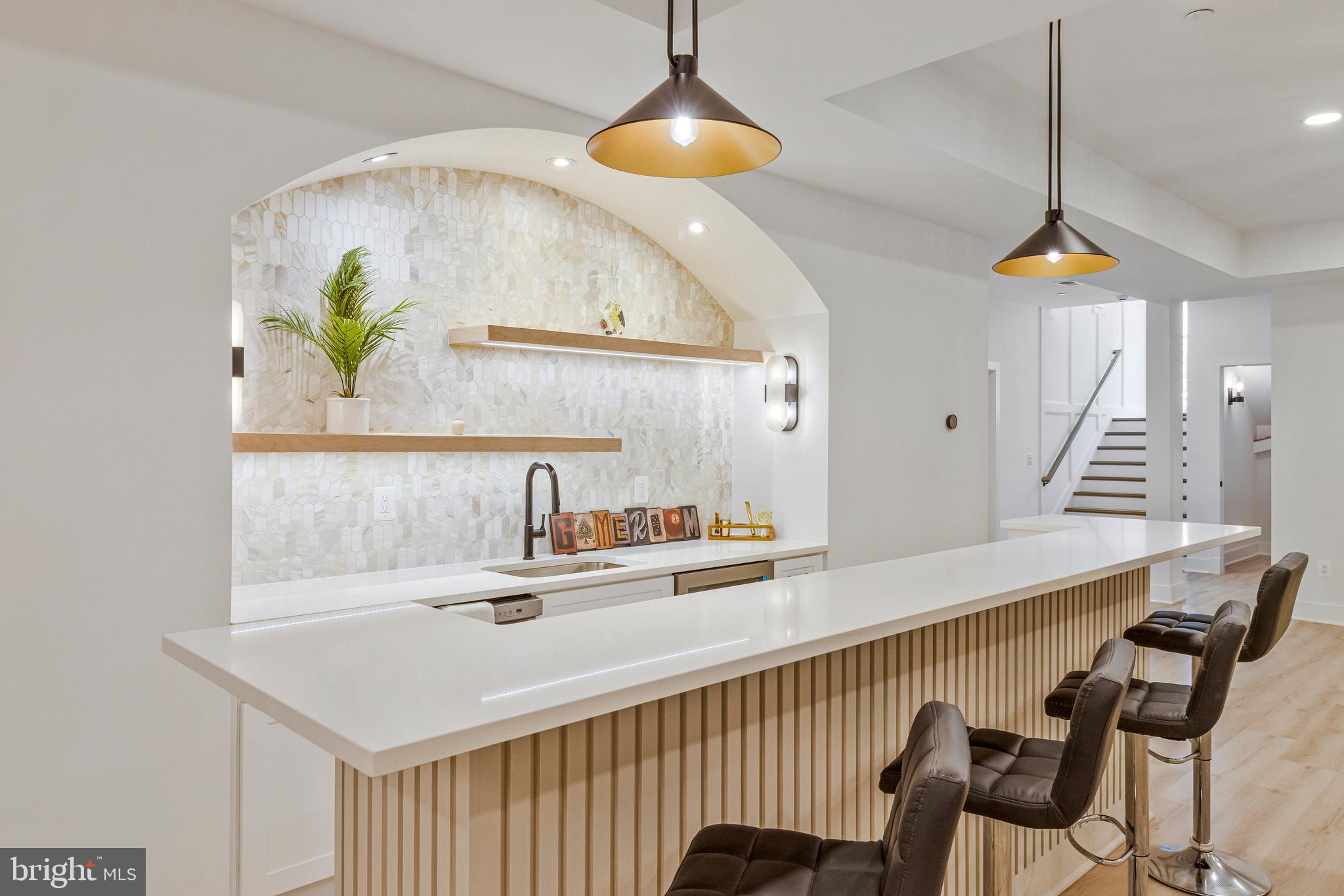 7709 Sebago Road Bethesda, MD 20817 - Photo 62 of 68 a kitchen with a table a sink and a chandelier