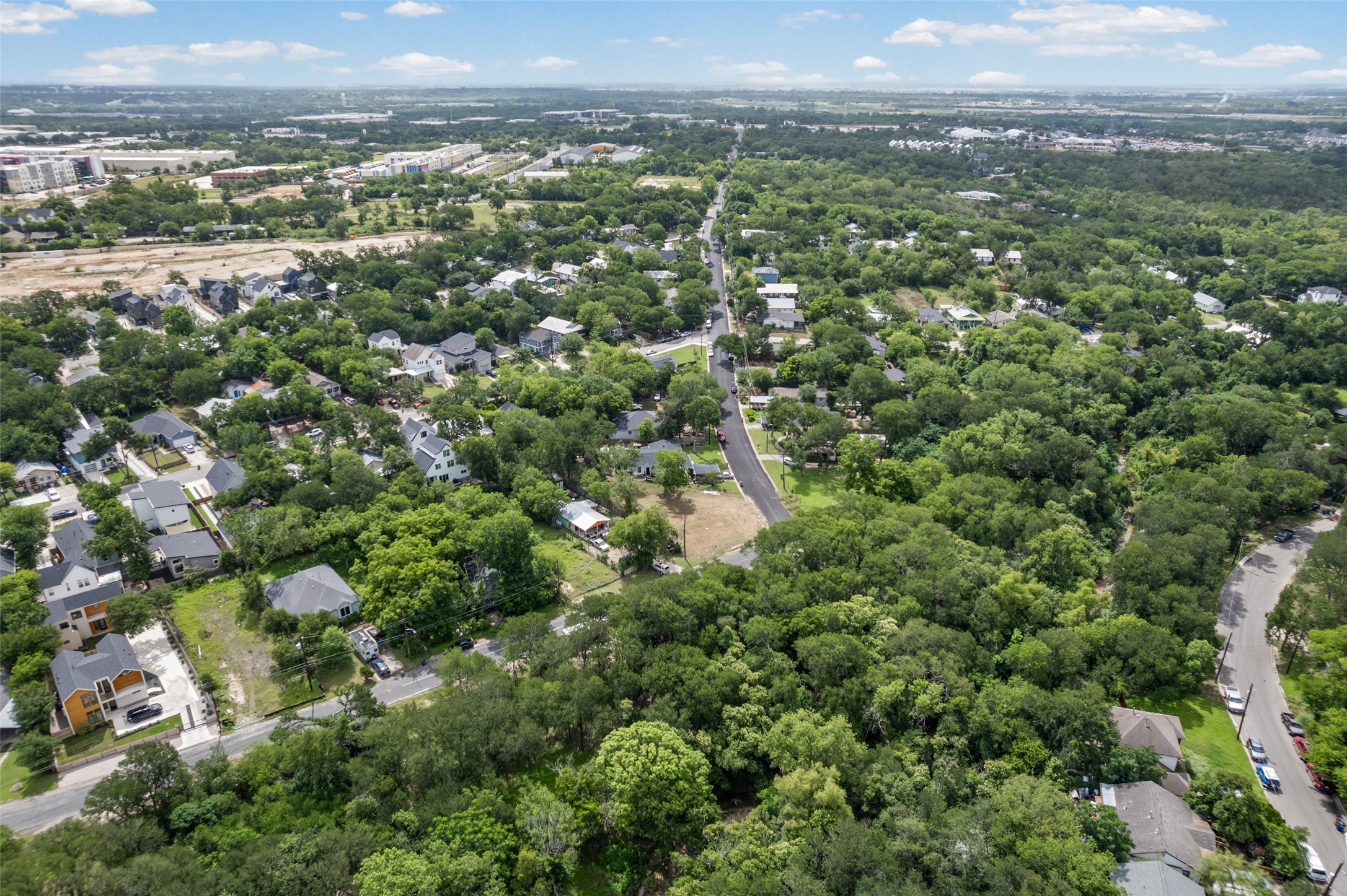1201 Fort Branch Boulevard Austin, TX 78721 - Photo 9 of 19 An aerial perspective reveals a verdant residential community woven amidst a network of mature trees and quiet streets.