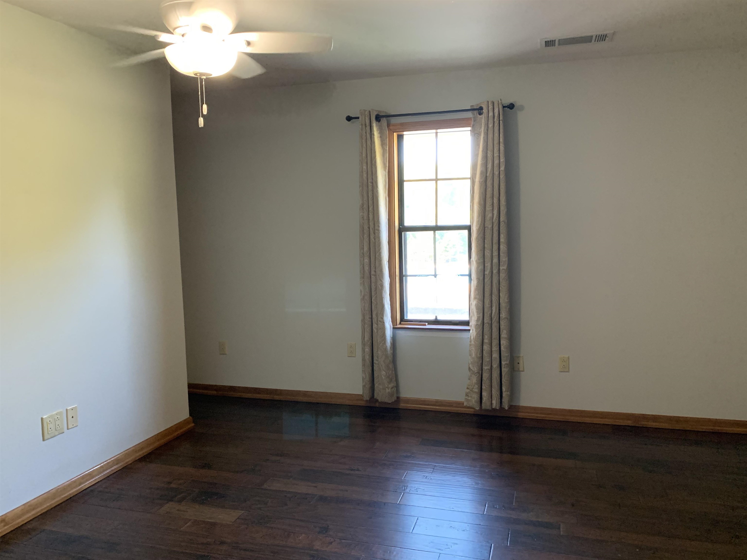 11280 Pleasant Ridge Road Arlington, TN 38002 - Photo 12 of 34 an empty room with wooden floor and windows