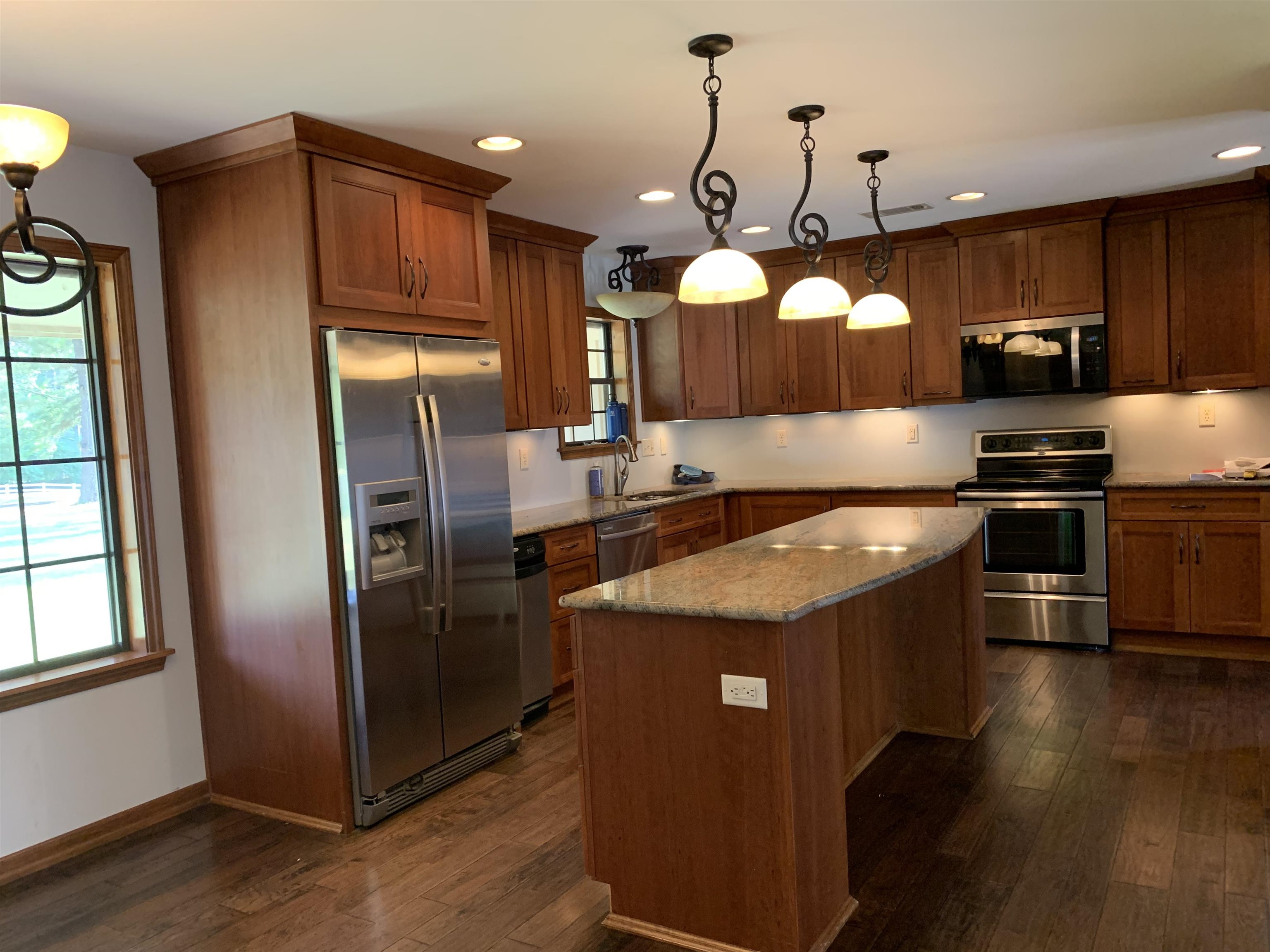 11280 Pleasant Ridge Road Arlington, TN 38002 - Photo 7 of 34 a kitchen with stainless steel appliances granite countertop a stove a refrigerator and a microwave