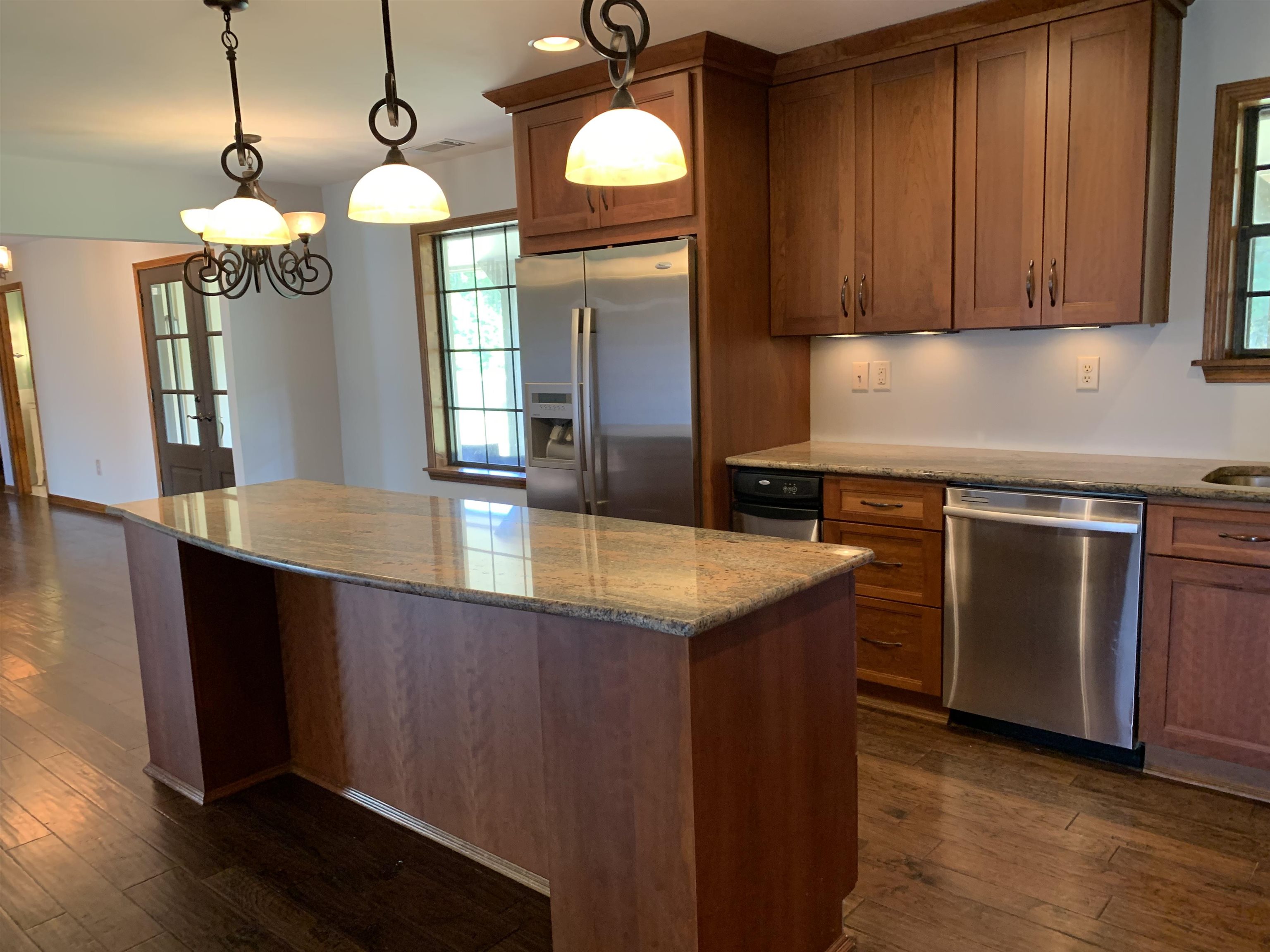 11280 Pleasant Ridge Road Arlington, TN 38002 - Photo 8 of 34 a kitchen with stainless steel appliances granite countertop wooden cabinets a stove a sink and a wooden floors