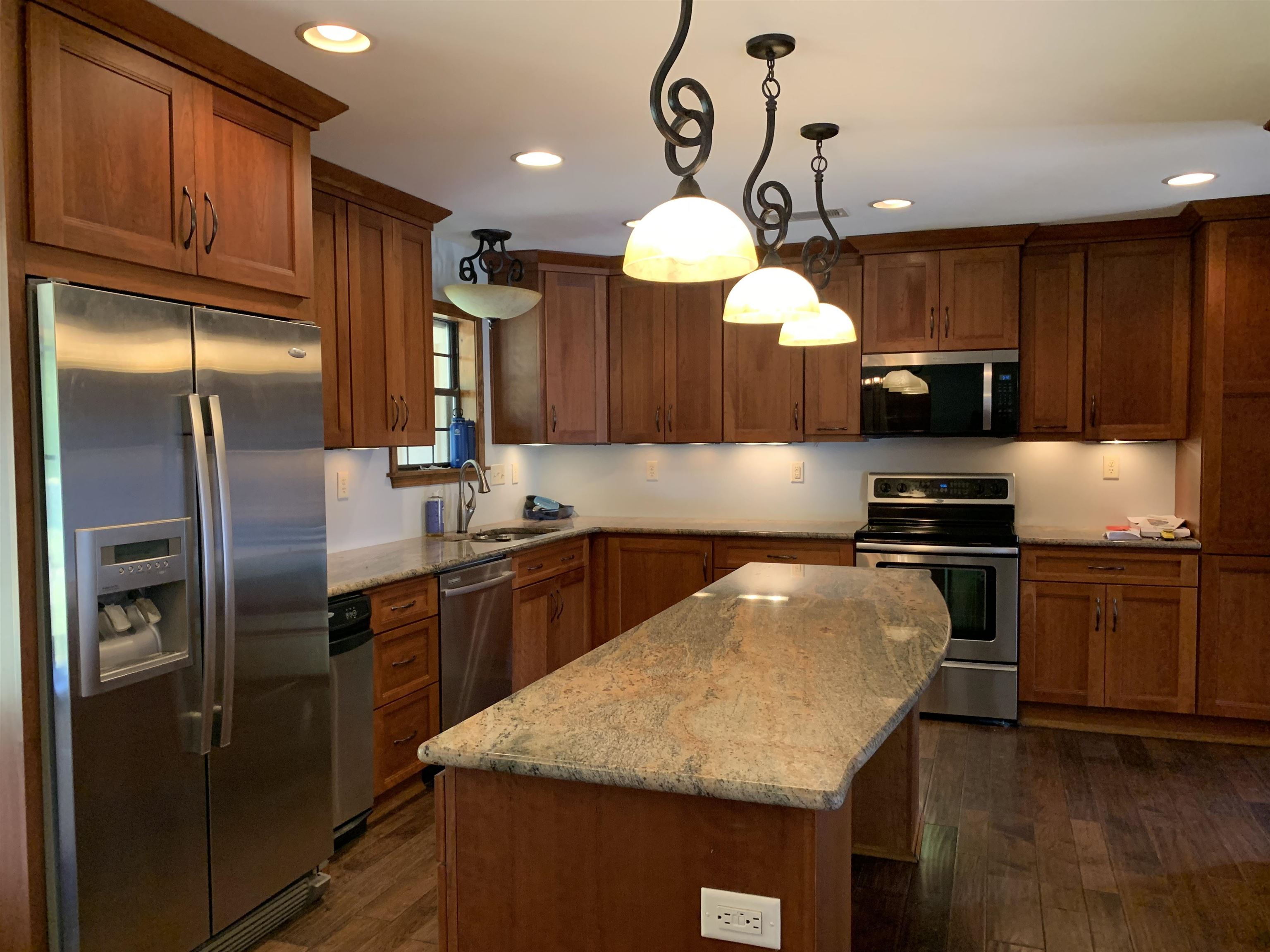 11280 Pleasant Ridge Road Arlington, TN 38002 - Photo 9 of 34 a kitchen with stainless steel appliances granite countertop a sink a stove and refrigerator