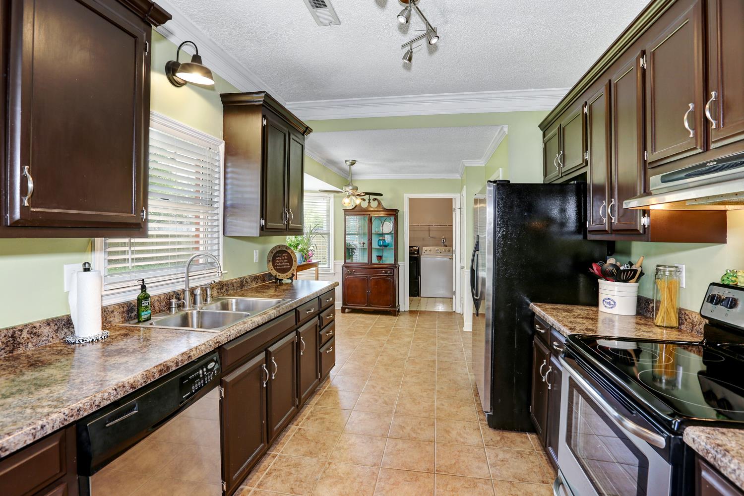 126 Raspberry Way Madison, AL 35757 - Photo 7 of 25 Kitchen - Opens to the breakfast area. Features include tile flooring and stainless steel appliances including dishwasher, stove and refrigerator plus a pantry.