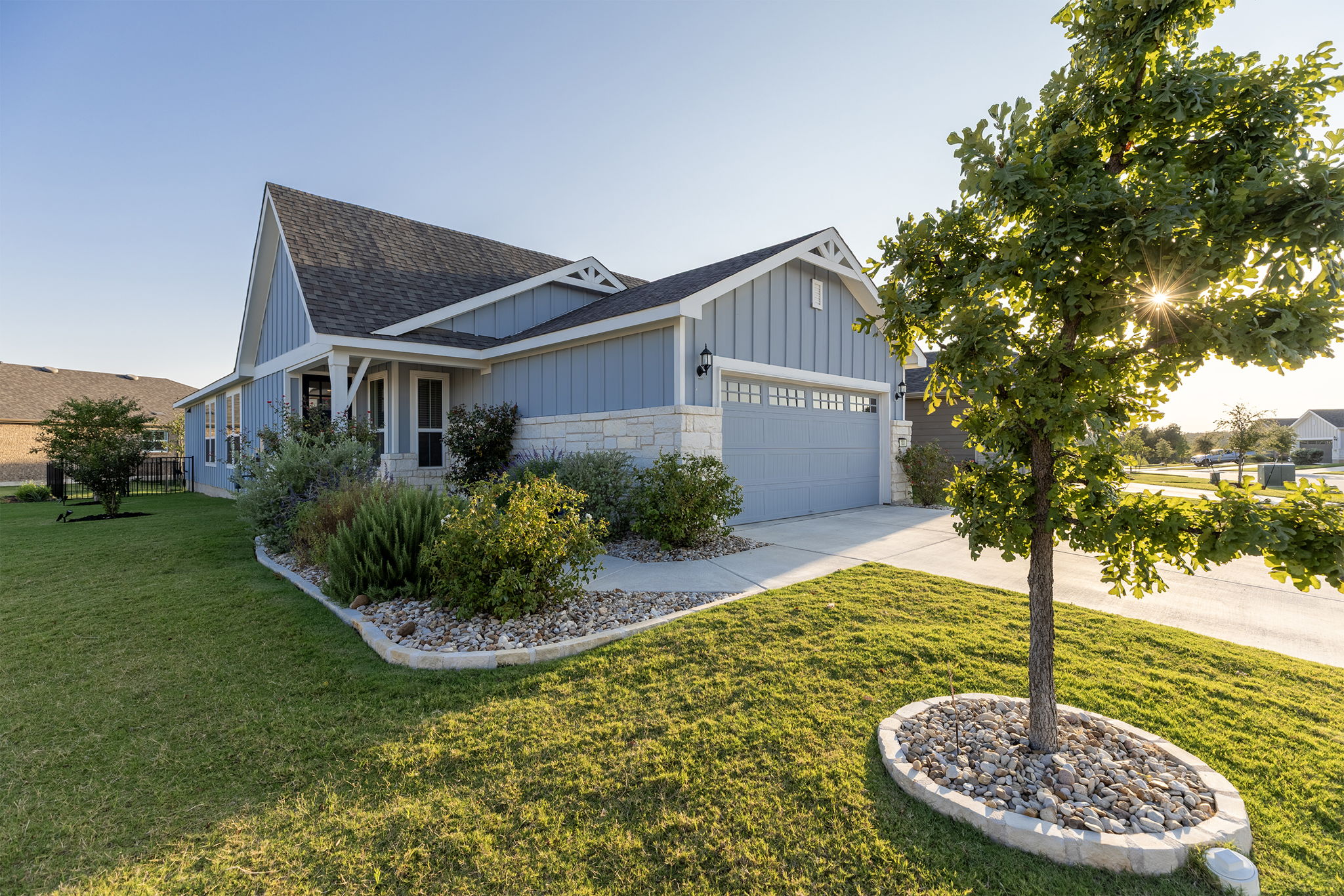 101 Bristol Cove Georgetown, TX 78633 - Photo 1 of 29 View of front of house featuring an attached garage, concrete driveway, a shingled roof, a front lawn, and stone siding