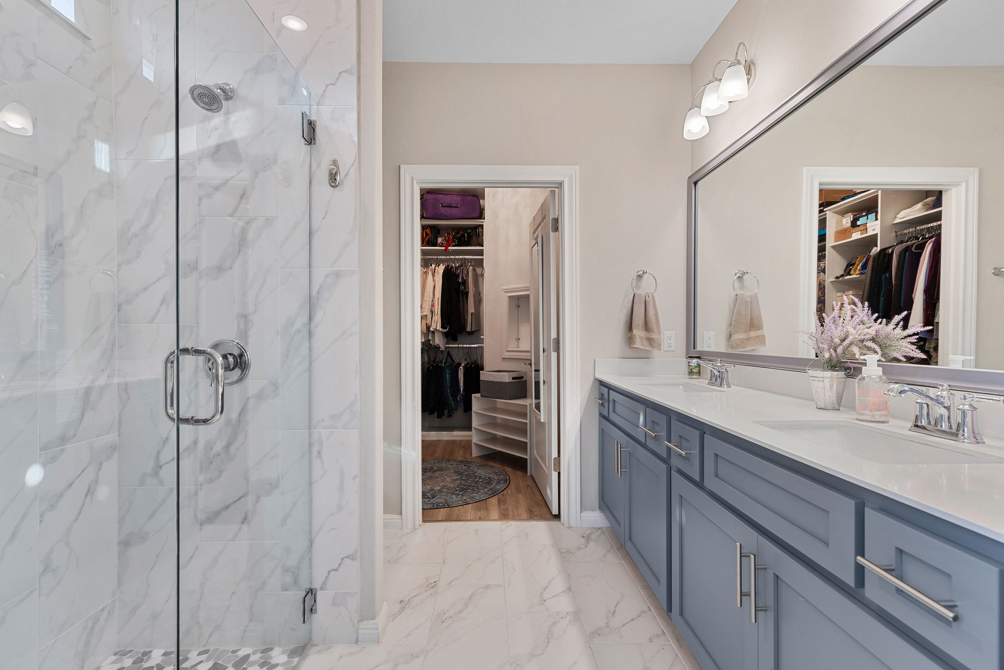 101 Bristol Cove Georgetown, TX 78633 - Photo 22 of 29 Bathroom featuring a walk in closet, double vanity, a marble finish shower, and light marble finish floors