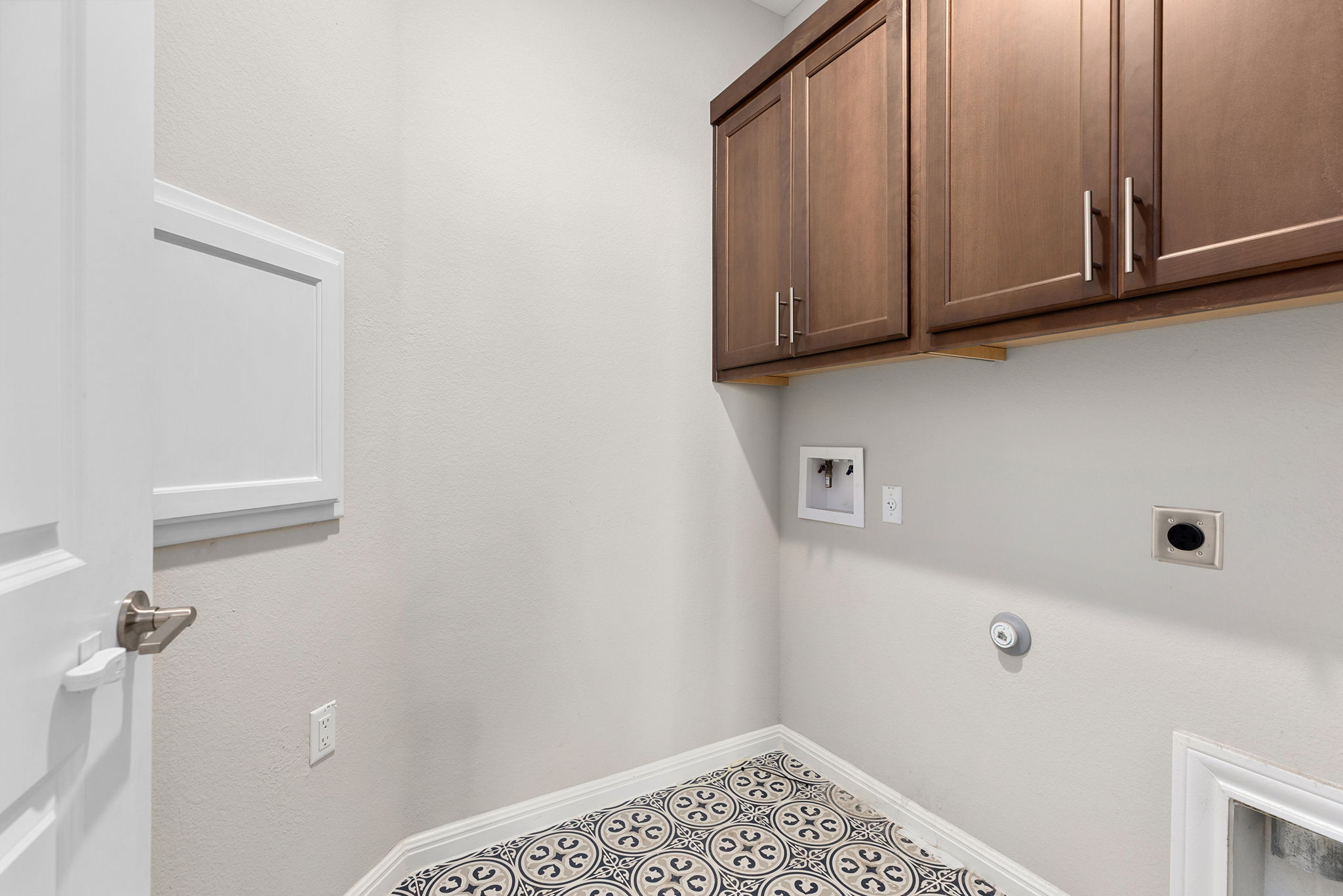 101 Bristol Cove Georgetown, TX 78633 - Photo 27 of 29 Laundry area with custom cabinets, washer hookup, tile patterned floors, and dryer hookup
