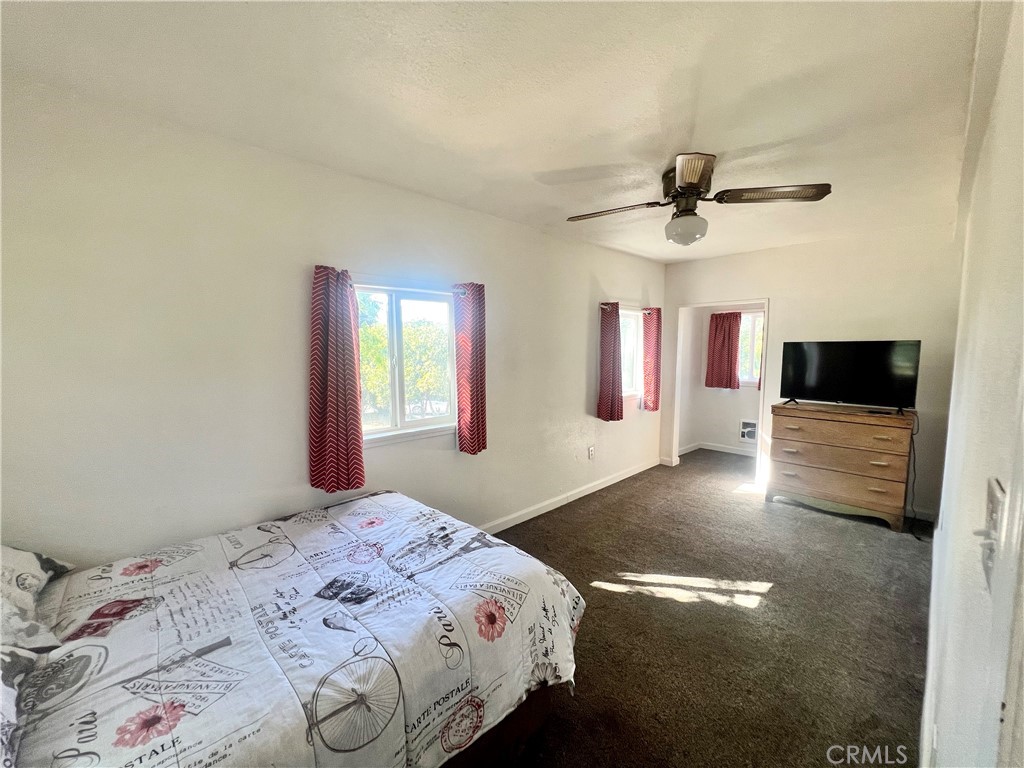 13992 Lakeshore Drive Clearlake, CA 95422 - Photo 15 of 35 a bedroom with a bed and a flat screen tv