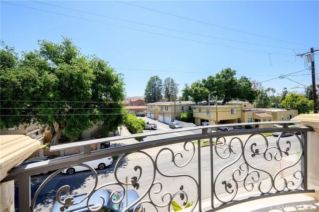 a view of a patio with table and chairs with wooden fence