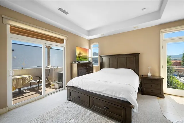 a bedroom with a large bed and a balcony view