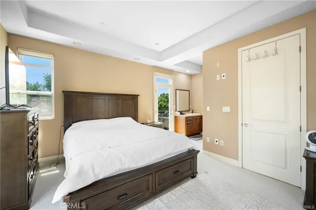a bedroom with a bed and large mirror