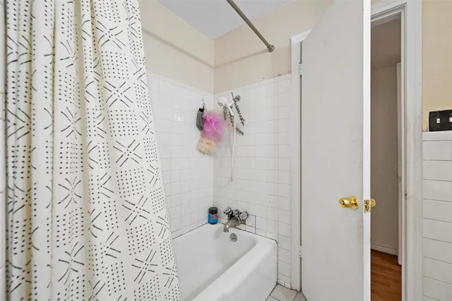 a bathroom with a bathtub and shower