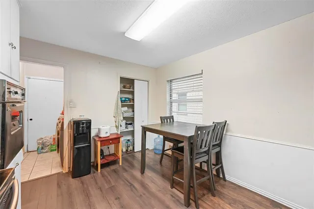 a view of a workspace with furniture and wooden floor