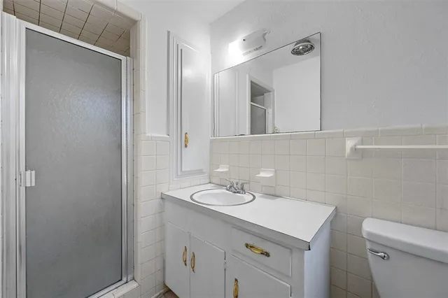 a bathroom with a sink toilet and mirror