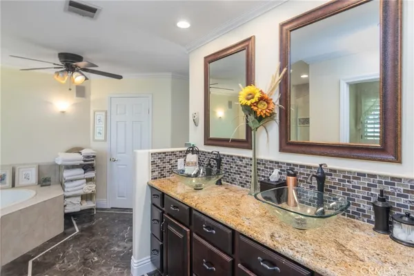 a bathroom with a granite countertop sink a toilet and mirror