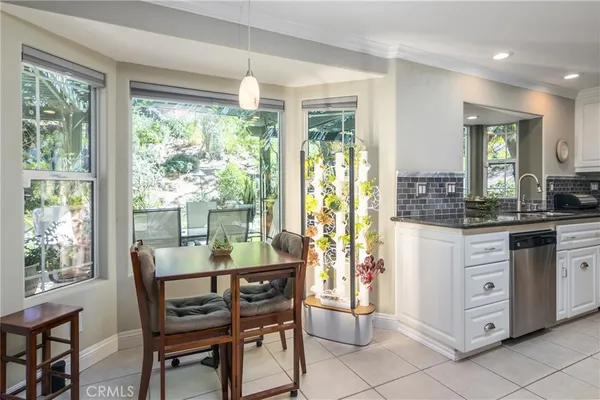 a dining room with furniture and large windows