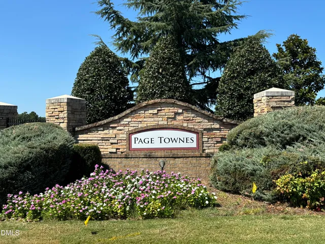 a sign that is sitting in front of flowers