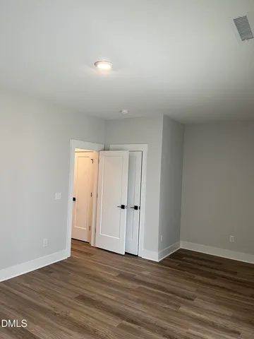 a view of an empty room and wooden floor