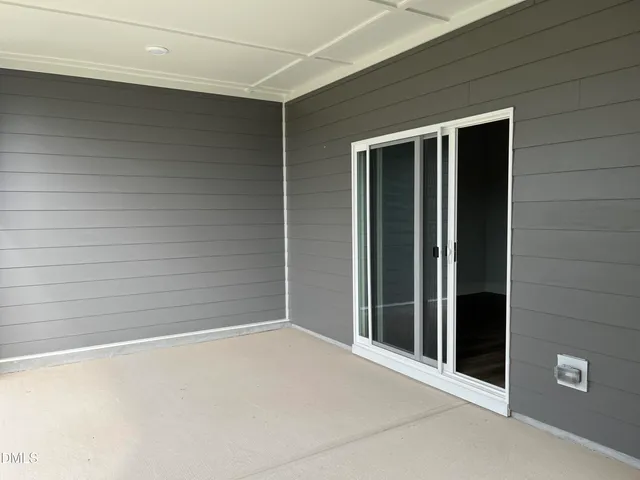 a large white kitchen with refrigerator stove and wooden floor