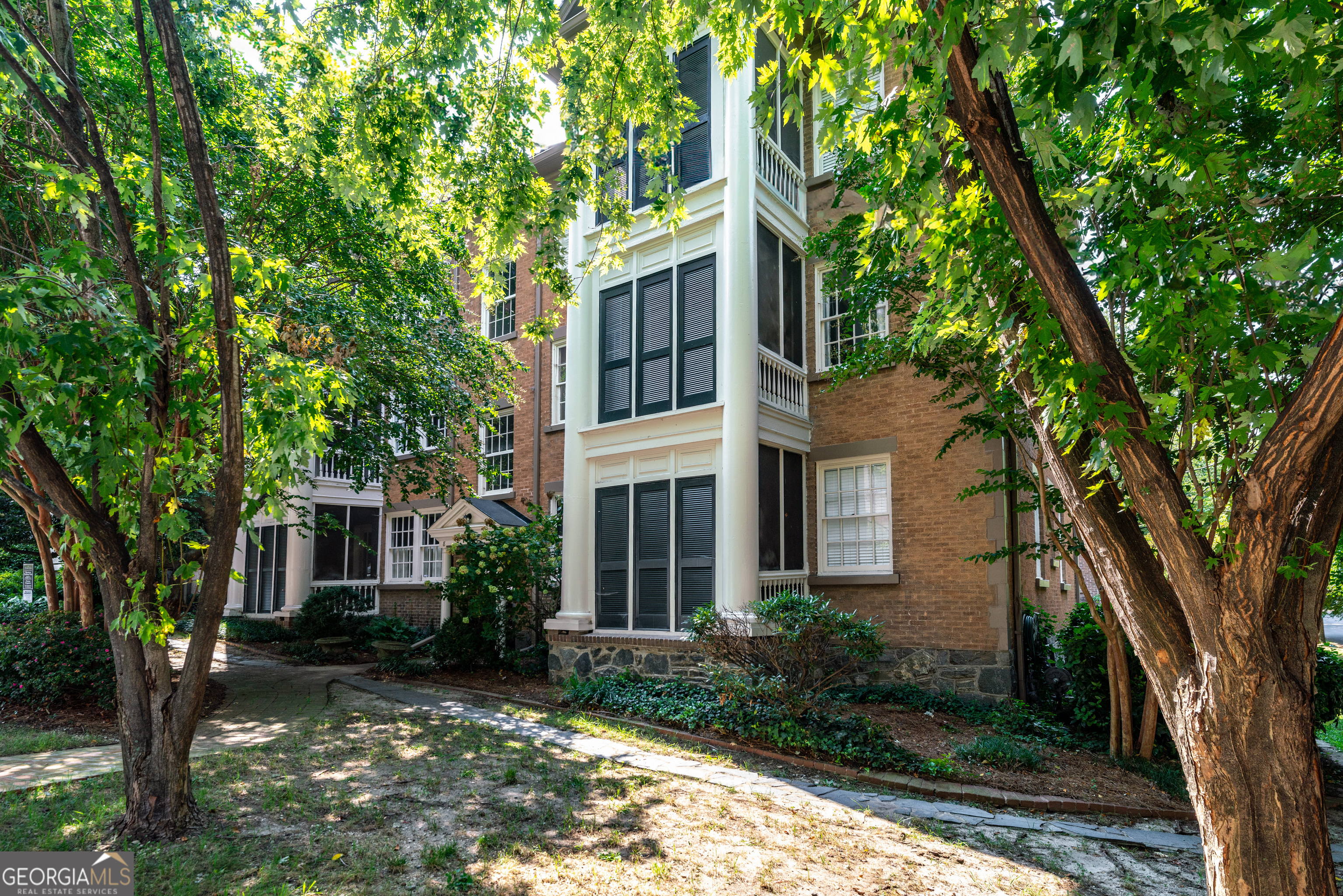 8 Collier Road Northwest, Unit B2 Atlanta, GA 30309 - Photo 1 of 1 front view of a house with a tree