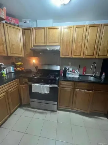 a kitchen with granite countertop a sink and cabinets