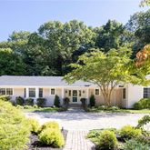 a view of an house with backyard space and garden