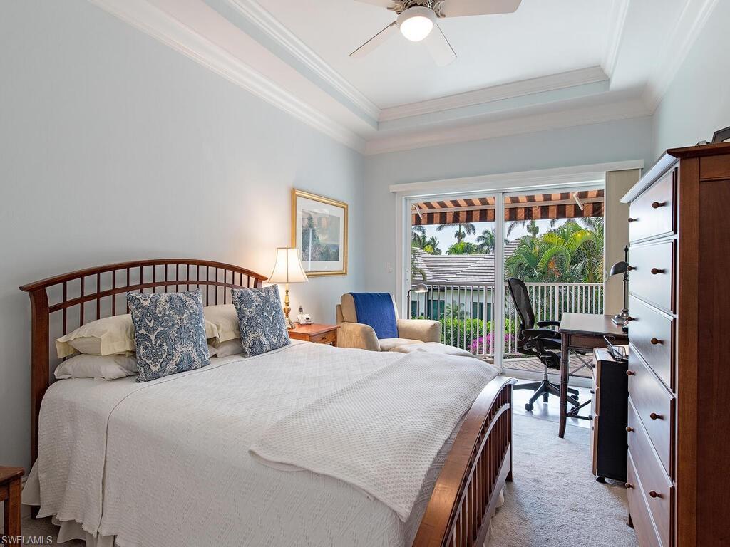 650 Bow Line Drive Naples, FL 34103 - Photo 15 of 18 a bedroom with a large bed and a chandelier