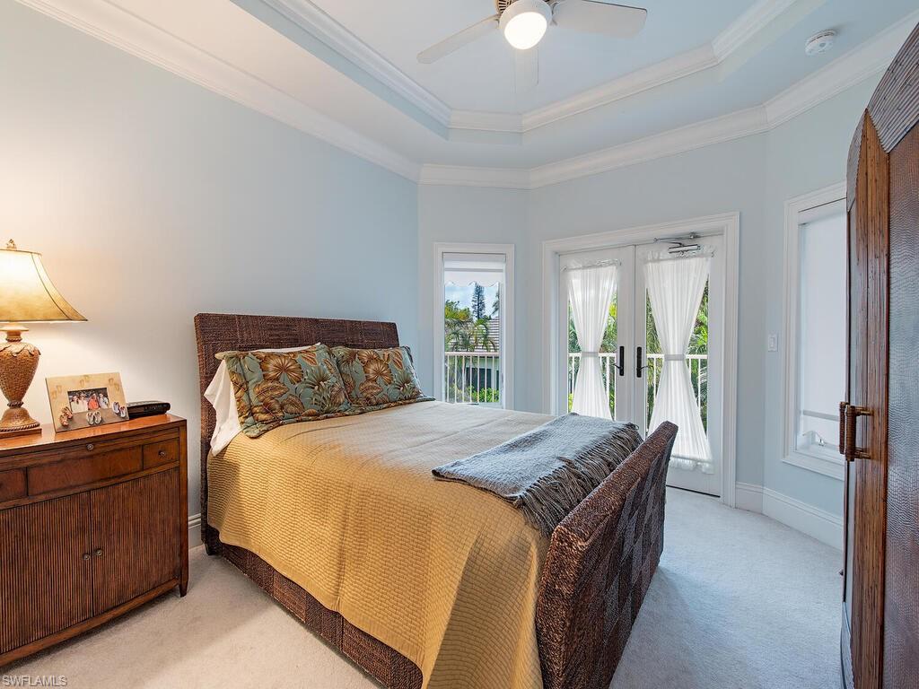 650 Bow Line Drive Naples, FL 34103 - Photo 16 of 18 a bedroom with a bed and a dresser next to a window