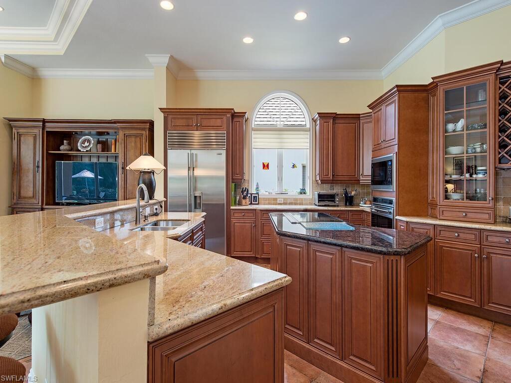 650 Bow Line Drive Naples, FL 34103 - Photo 5 of 18 a kitchen with stainless steel appliances granite countertop a sink and cabinets