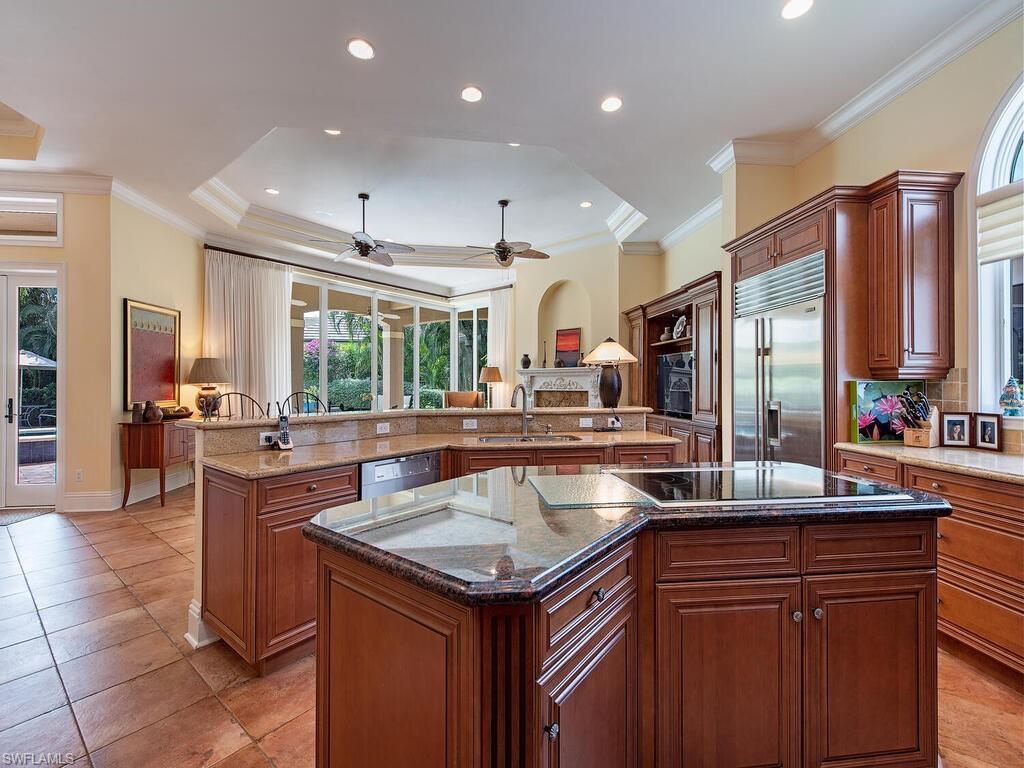 650 Bow Line Drive Naples, FL 34103 - Photo 6 of 18 a kitchen with a sink stove and cabinets