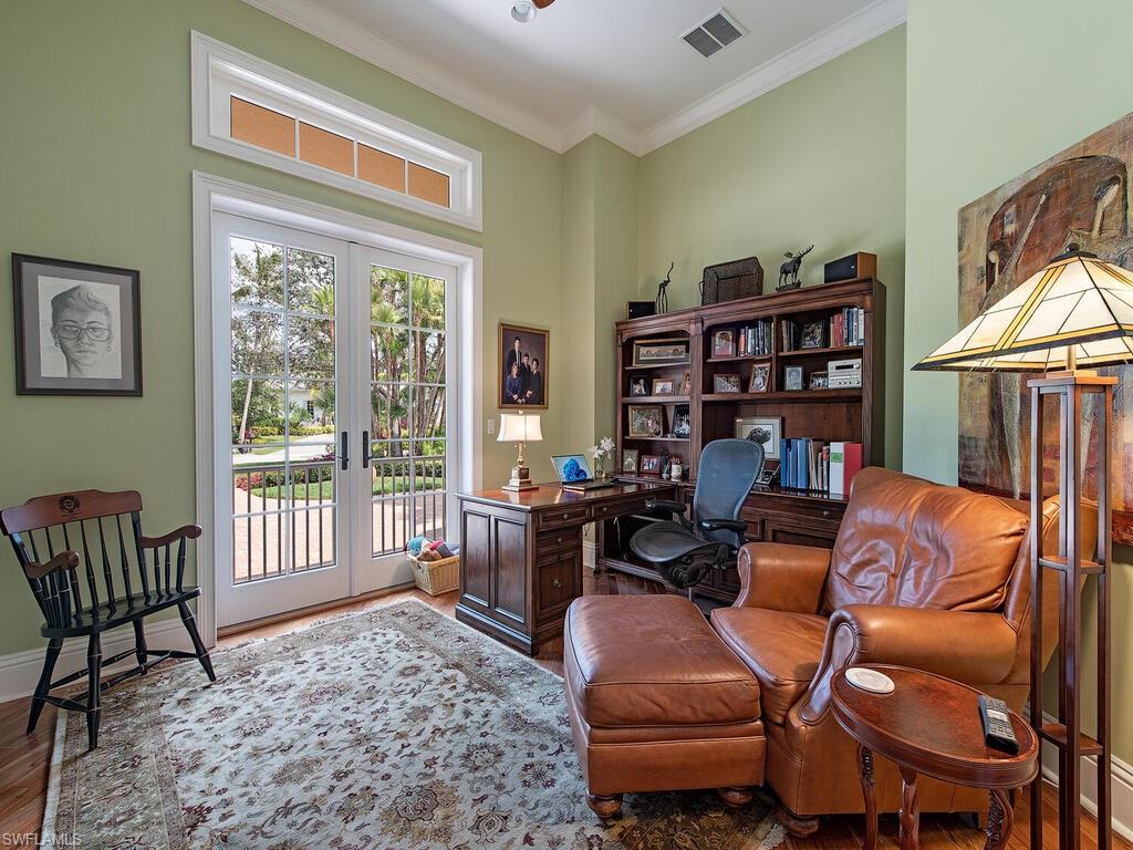 650 Bow Line Drive Naples, FL 34103 - Photo 9 of 18 a living room with furniture a bookshelf and a window