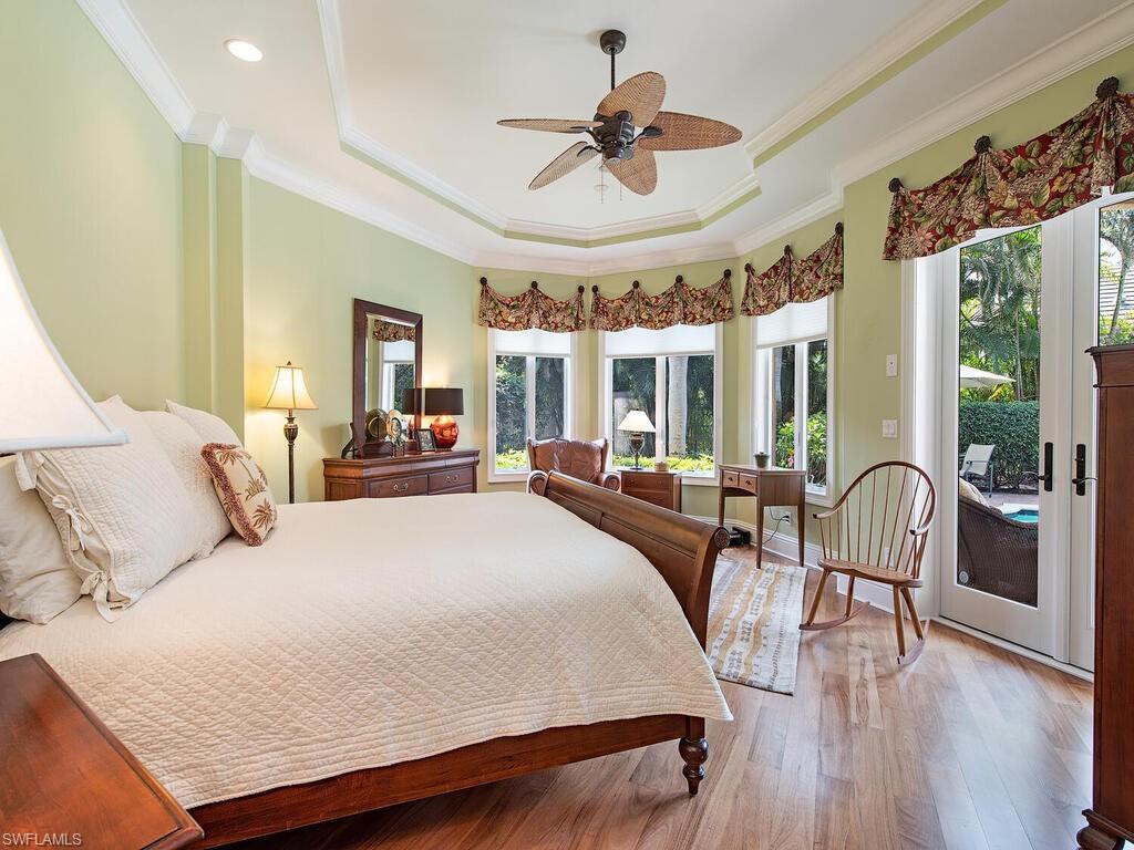 650 Bow Line Drive Naples, FL 34103 - Photo 10 of 18 a bedroom with a bed a large window and furniture
