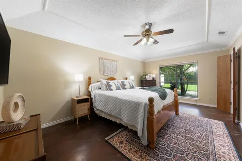 a bedroom with a bed rug and wooden floor