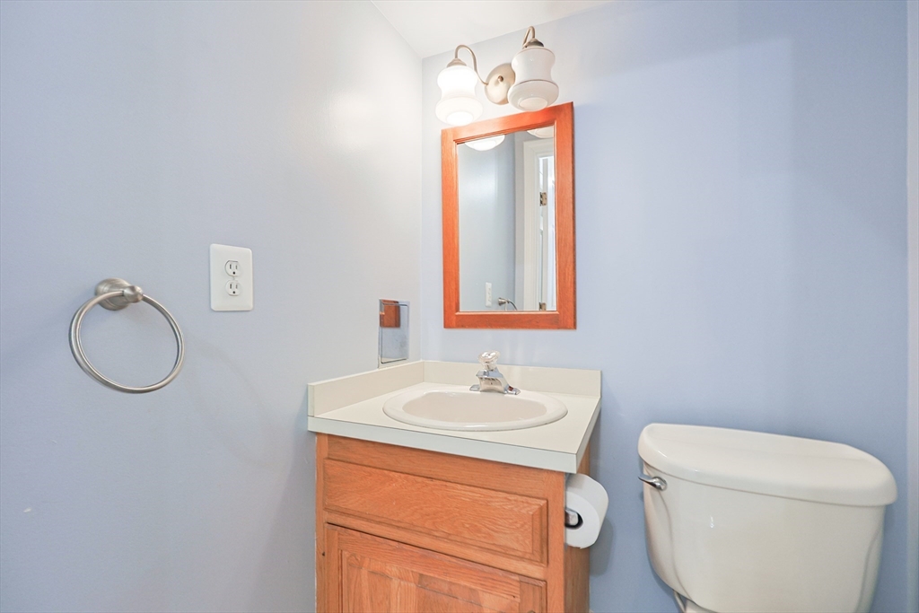 17 Quisset Brook Road, Unit 17 Milton, MA 02186 - Photo 14 of 40 a bathroom with a toilet sink vanity and mirror