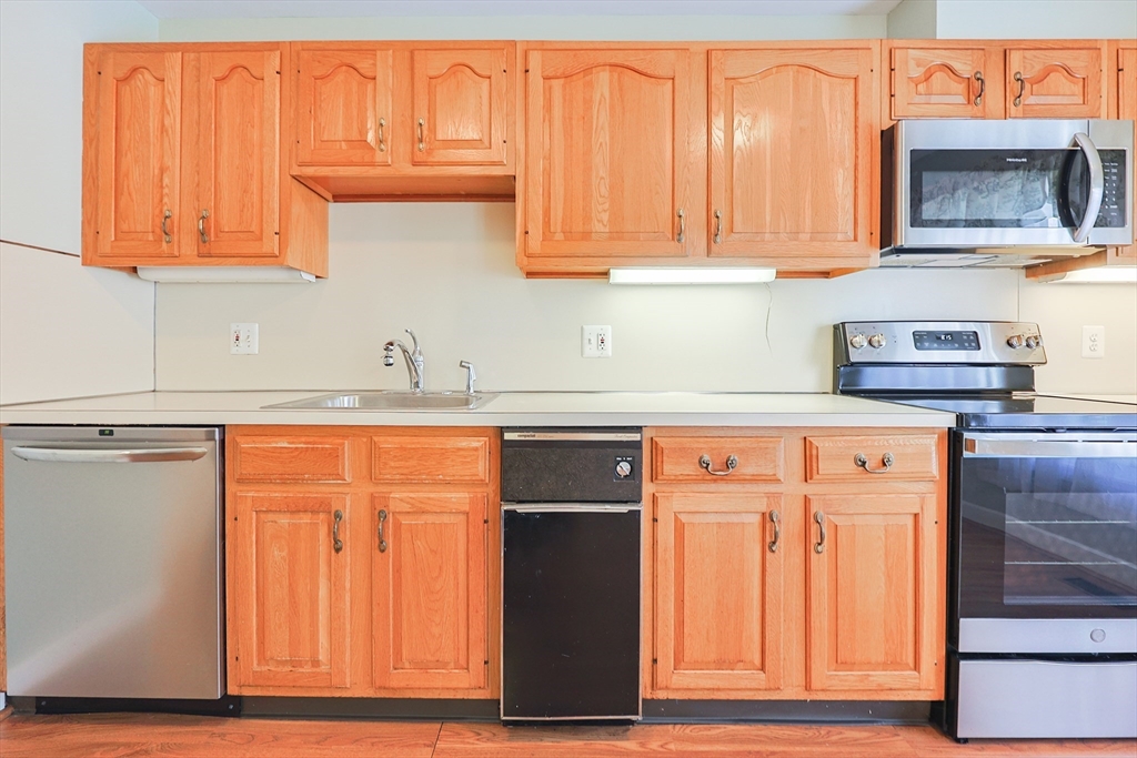 17 Quisset Brook Road, Unit 17 Milton, MA 02186 - Photo 18 of 40 a kitchen with stainless steel appliances granite countertop a refrigerator and cabinets