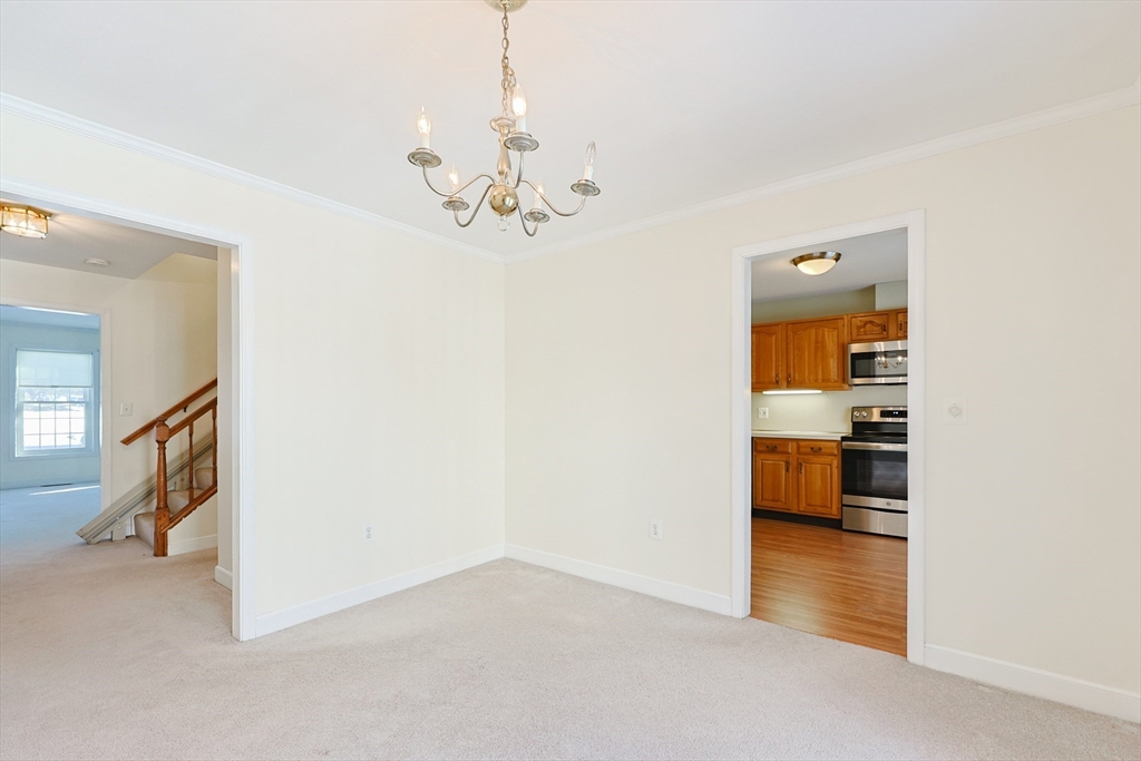 17 Quisset Brook Road, Unit 17 Milton, MA 02186 - Photo 21 of 40 a view of a kitchen with a sink and a chandelier