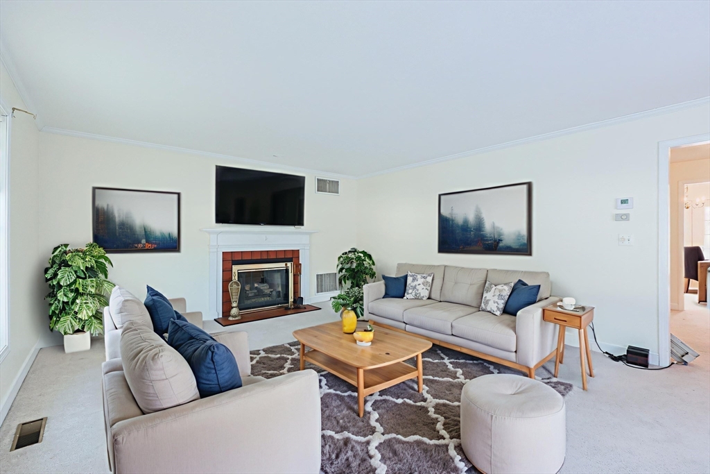 17 Quisset Brook Road, Unit 17 Milton, MA 02186 - Photo 5 of 40 a living room with furniture a fireplace and a flat screen tv