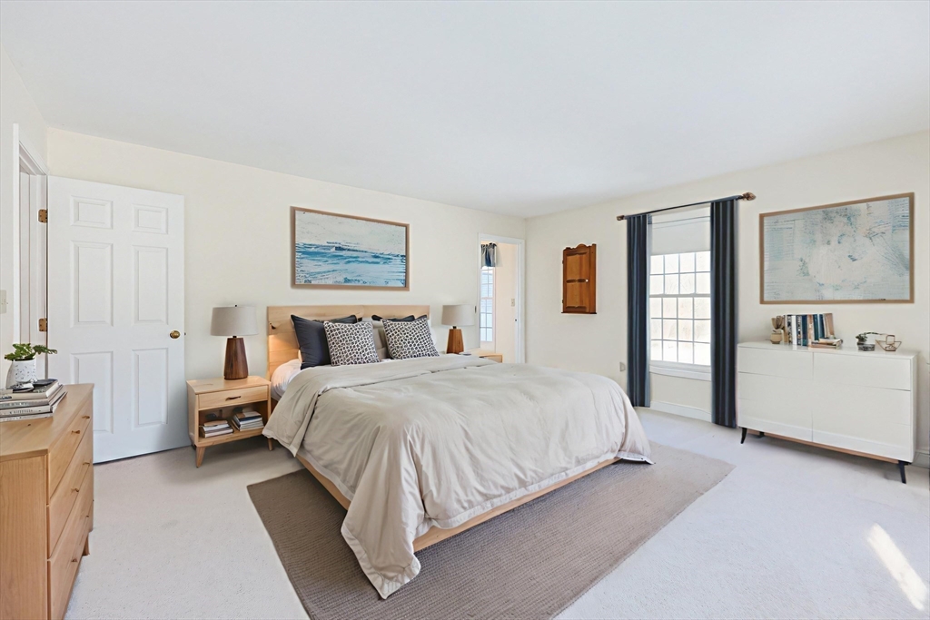 17 Quisset Brook Road, Unit 17 Milton, MA 02186 - Photo 9 of 40 a spacious bedroom with a large bed and a couch