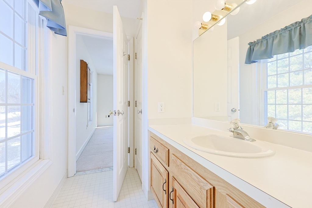 17 Quisset Brook Road, Unit 17 Milton, MA 02186 - Photo 10 of 40 a bathroom with a sink and a mirror