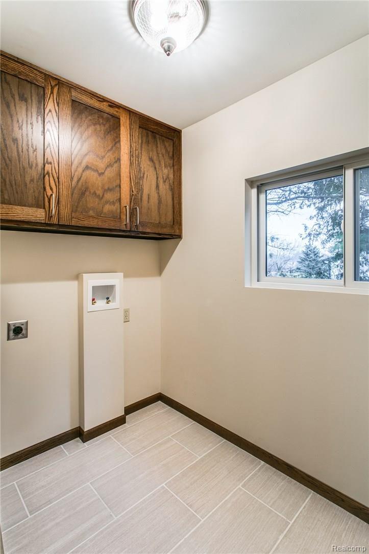 6094 Jeddo Road Jeddo, MI 48032 - Photo 14 of 24 LAUNDRY ROOM PORCELAIN TILE AND BEAUTIFUL STORAGE AT ENTRY LEVEL!