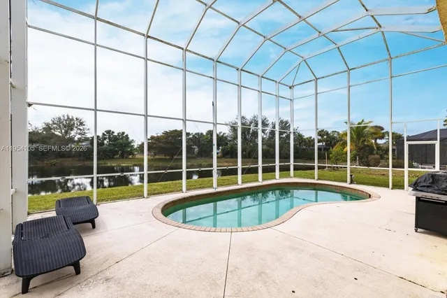 a view of a house with swimming pool and sitting area