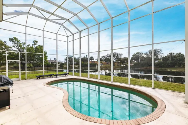 a view of house with yard and sitting area