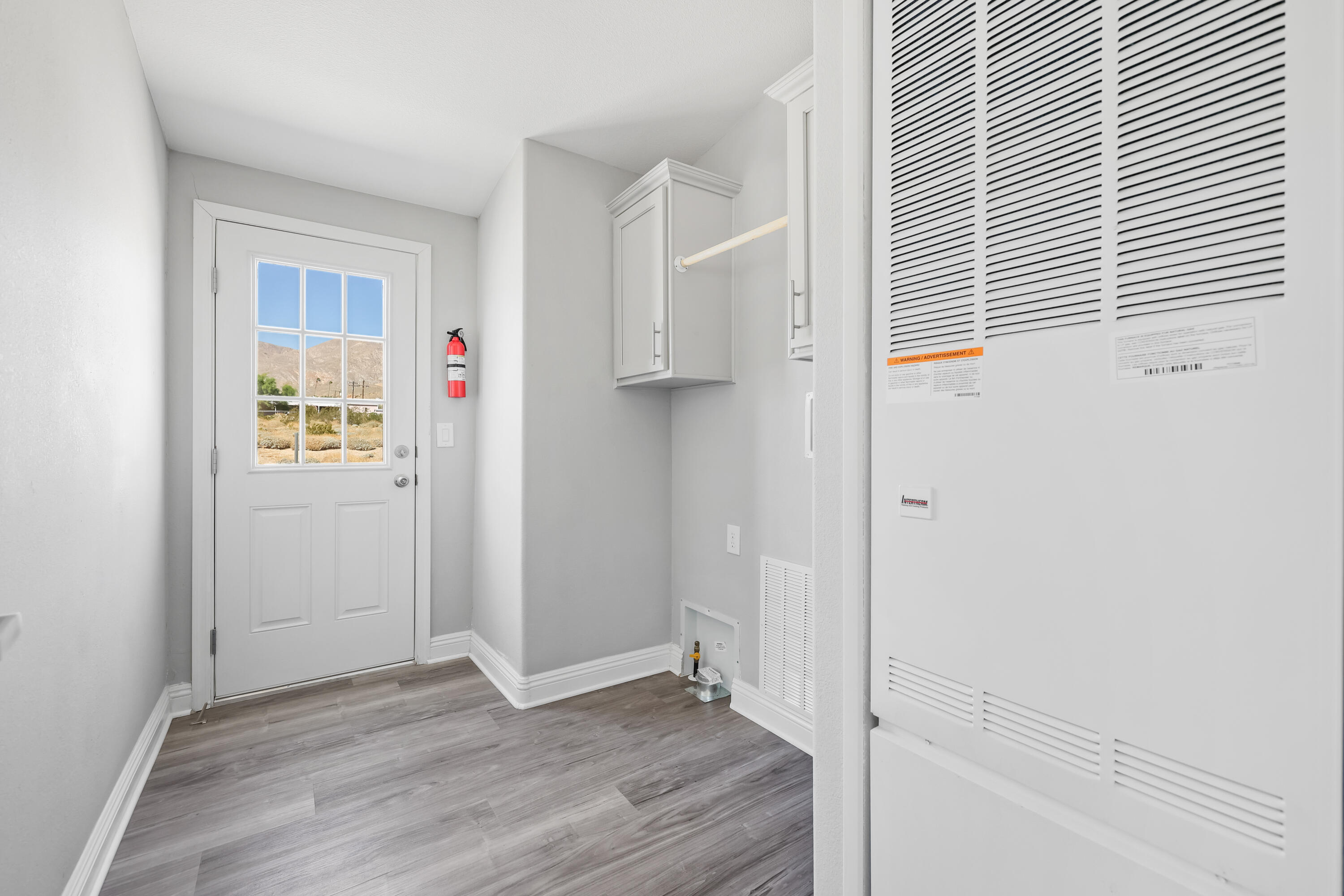 13446 Cholla Road Whitewater, CA 92282 - Photo 17 of 30 an empty room with wooden floor and windows