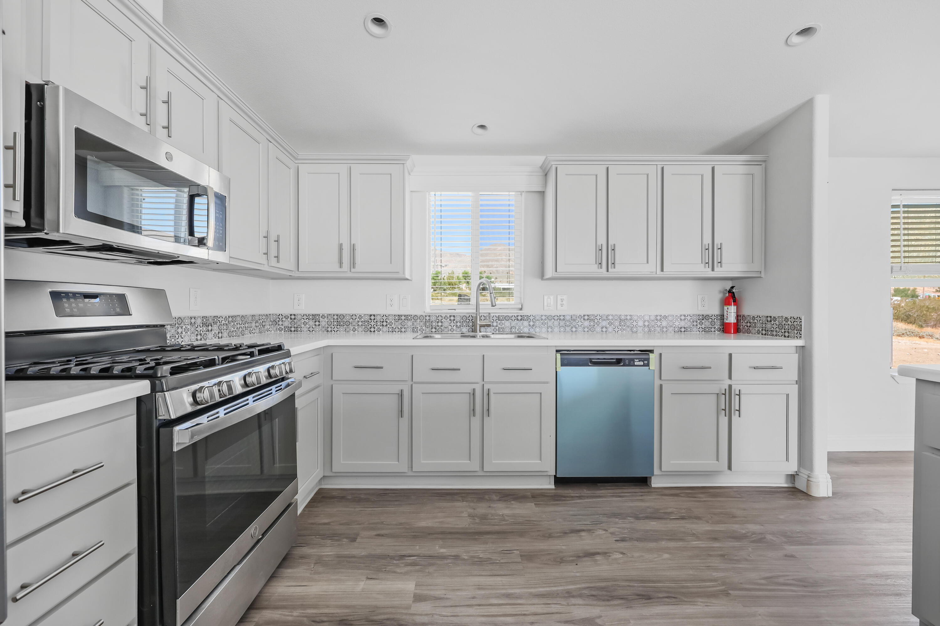 13446 Cholla Road Whitewater, CA 92282 - Photo 2 of 30 a kitchen with stainless steel appliances granite countertop a stove a sink and white cabinets