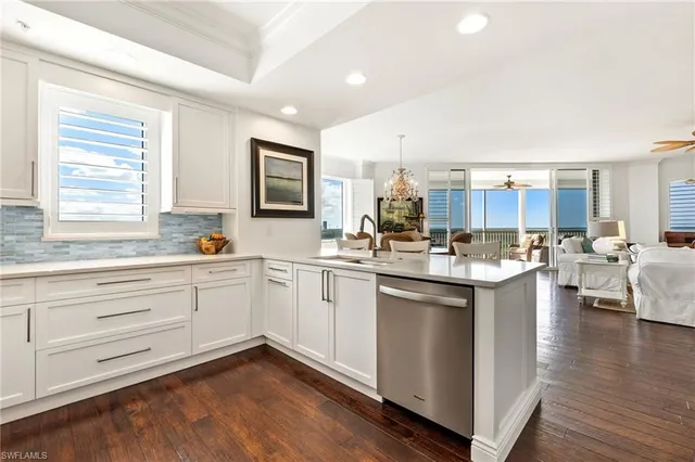 a kitchen with a sink cabinets and wooden floor