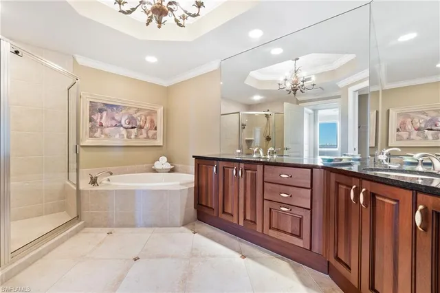 a spacious bathroom with a bathtub double sink and a mirror