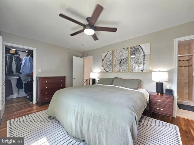 a bedroom with a large bed and a chandelier
