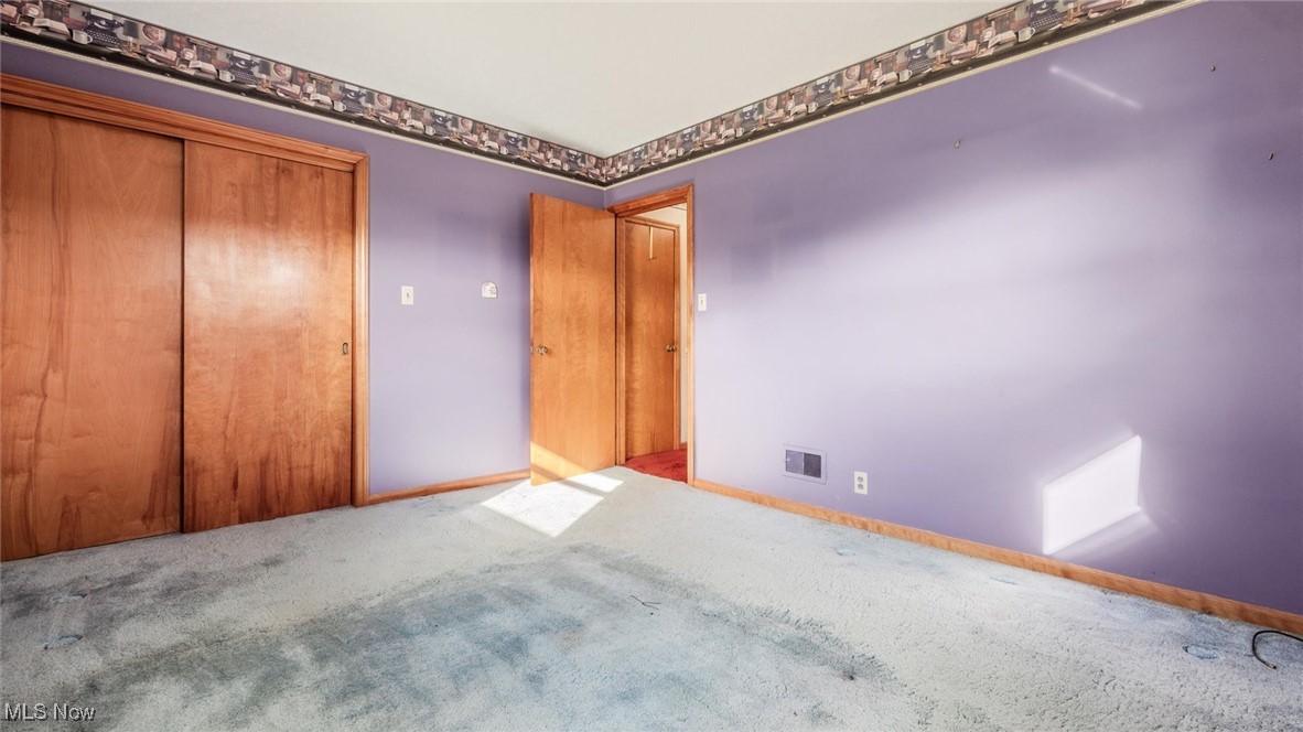 1950 Newark Road Zanesville, OH 43701 - Photo 21 of 39 Unfurnished bedroom with light carpet and a closet
